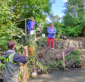 Volunteers building berms at Dodham Brook