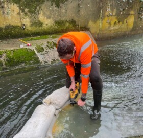 A contractor carrying out works in the Dodham Brook Restoration works to improve wildlife habitat and visual aesthetics