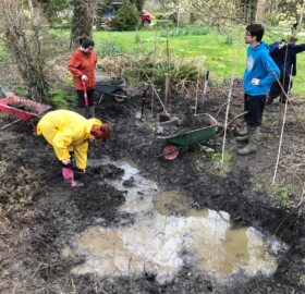Lorna with Able2achieve learners helping to dig pond at The Geranium Trust